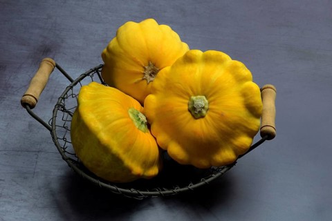 Yellow patisson pumpkins in wire basket