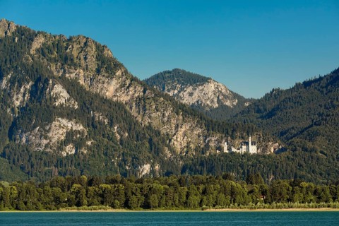 View over the Forgensee to Neuschwanstein Castle and the Tannheimer Mountains