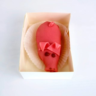 Marzipan pig in a box of pastry