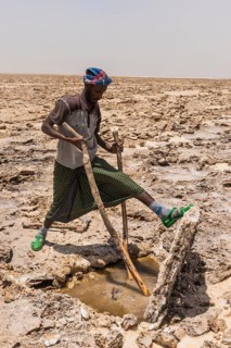 Afar nomad cutting and lifting out salt plates