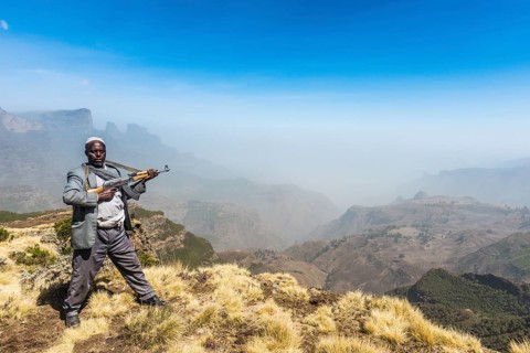 Sentry with rifle in the mountains