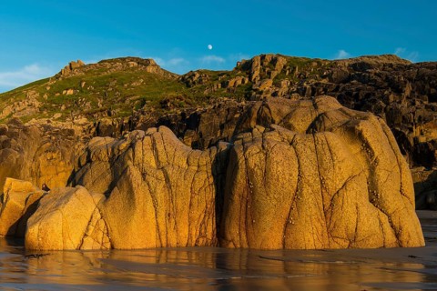 Moon above the rocky coast at Porth Nanven