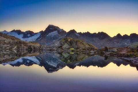 Graetlisee with reflection of the mountains in the morning light