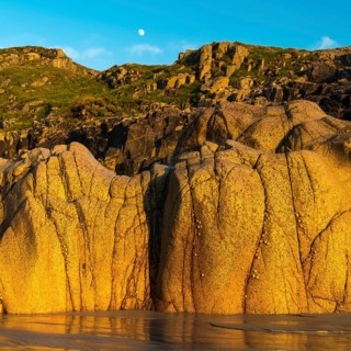 Moon above the rocky coast at Porth Nanven