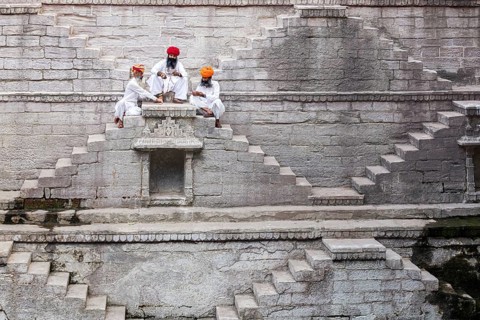 Three men playing cards at the stepwell Toorji Ka Jhalra