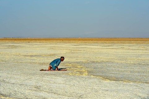 Believer Muslim praying in the desert