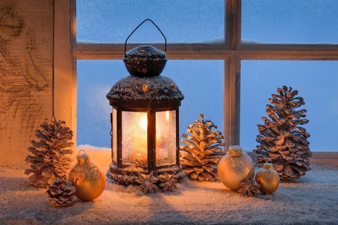 Lantern with Christmas decoration on windowsill