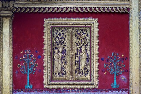 Carved mock window flanked by glass mosaic trees