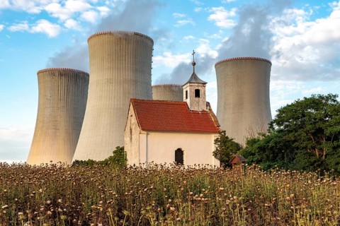Old abandoned chapel and cooling towers of Dukovany Nuclear Power Station