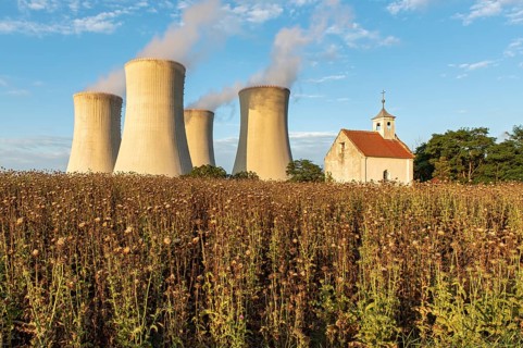 Old abandoned chapel and cooling towers of Dukovany Nuclear Power Station