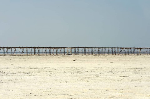 Pipeline on stilts on the Assale Salt Lake for the transport of brine to the evaporation basins of a salt works