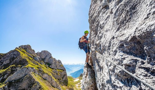 Young man climbing a rock face