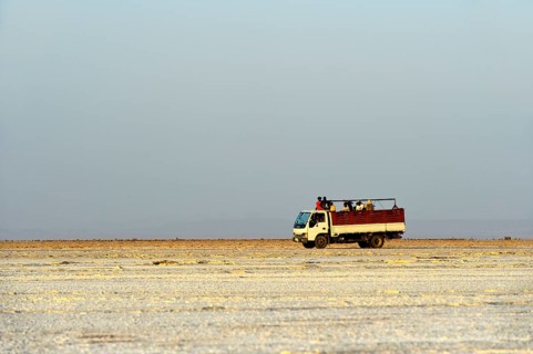 Truck drives with workers from the salt mine across the Assale Salt Lake to Hamadela