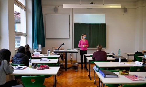 Teacher with face mask in classroom