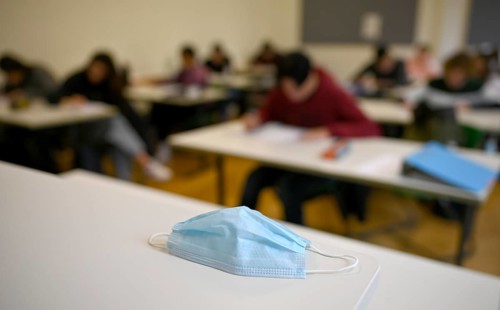 Face mask on student's desk