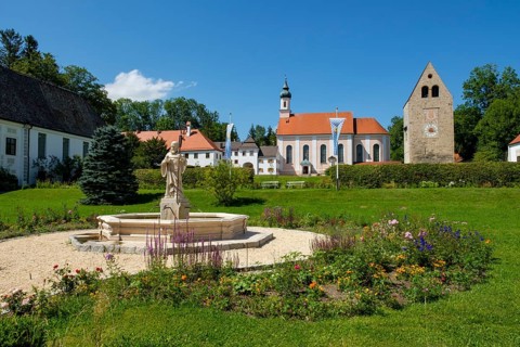 Monastery church with Roman tower and fountain with fountain figure of abbot Walto or Balto