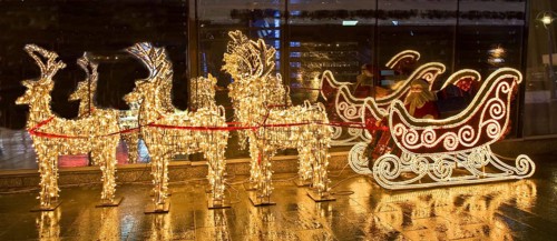 Electric sculptures of golden deers and carriage with Santa Claus