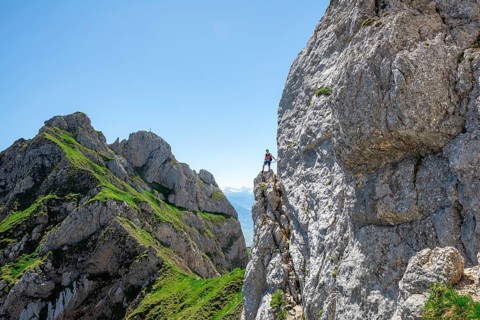 Young man climbing a rock face