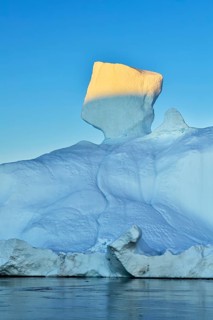 Evening atmosphere with sunlit iceberg