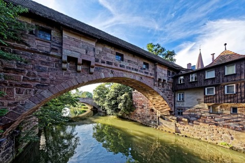 View from Kettensteg to Fronveste and Hallertor bridge over the river Pegnitz