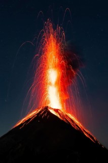 Glowing lava and smoke spitting volcano