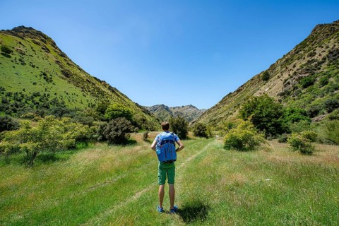 Hiker on trail in a valley