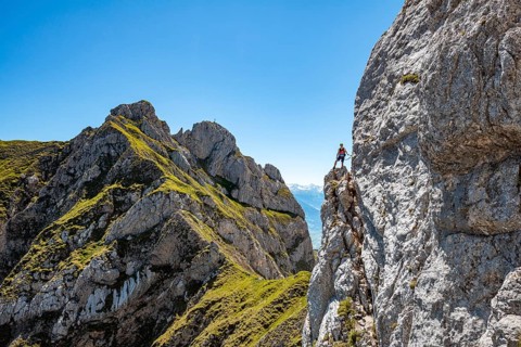 Young man climbing a rock face