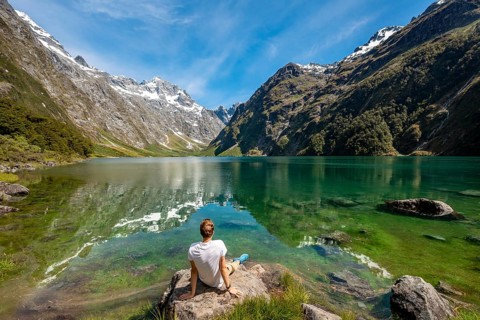 Hiker sitting on the shore