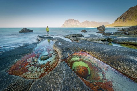 Woman standing on rocks on the beach