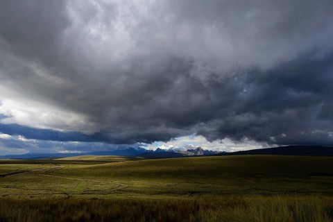 Mountain range of the Cordillera Blanca under dark clouds