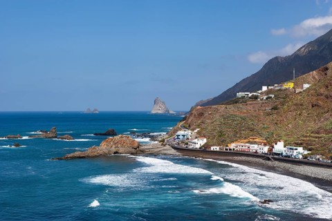 Coastal road with cliffs in the Anaga Mountains with beach section Playa de Roque de las Bodegas near the township of Taganana