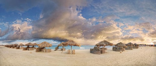 Sandy beach beach with umbrellas at the coral reef Abu-Dabbab