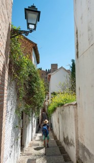 Young man standing in an alley