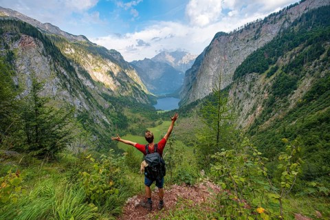 Hiker stretches arms in the air