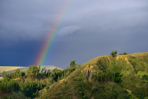 Rainbow in front of dark clouds