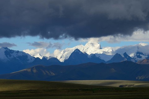 Mountain range of the Cordillera Blanca under dark clouds