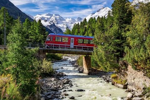 Train of the Bernina line in the Morteratsch valley with Bellavista and Piz Bernina