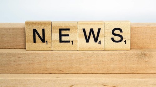 Letter blocks on a wooden bar form the word News