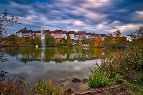 Reflection of the old town of Wil in the pond of the municipal park