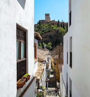 Alley with view of the towers of the Alhambra