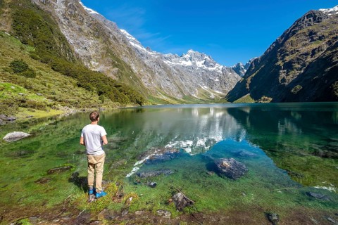 Hiker stands on shore
