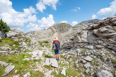 Hikers in a landscape of washed out karst rocks