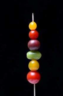 Various cherry tomatoes on wooden skewers