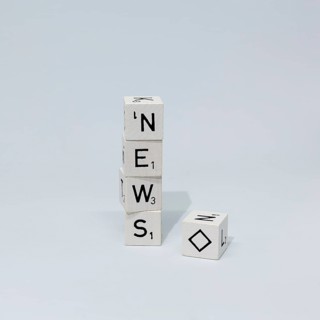 Cubes of letters stacked on top of each other form the word News
