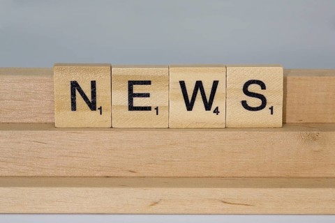 Letter blocks on a wooden bar form the word News