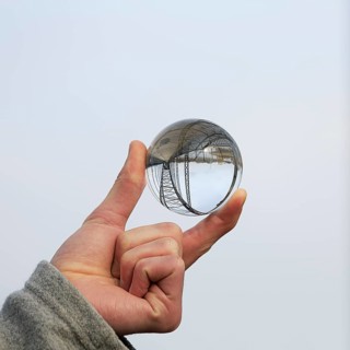 Hand holding glass ball