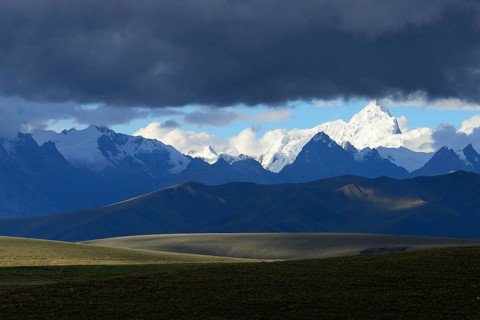 Mountain range of the Cordillera Blanca under dark clouds