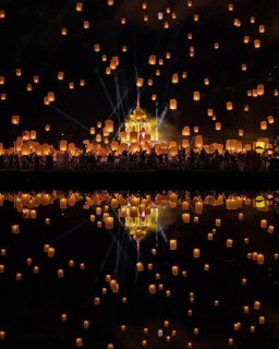Yi Peng Festival with rising lanterns and a reflection in the lake