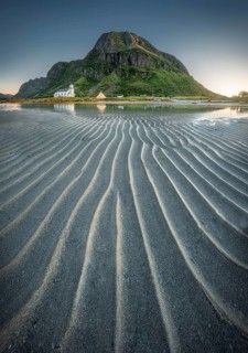 Gimsoy church reflected in the sea at low tide