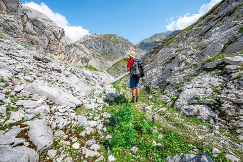 Hikers in a landscape of washed out karst rocks